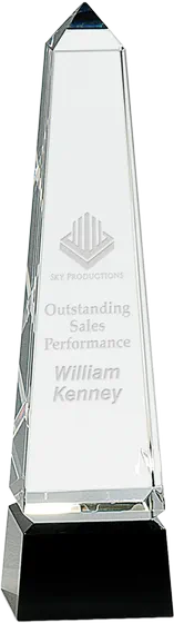 Tall crystal obelisk award on a black pedestal base, engraved Outstanding Sales Performance